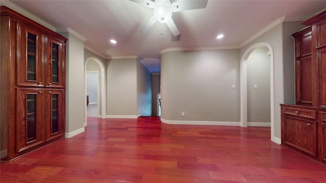 unfurnished room with ceiling fan, dark hardwood / wood-style floors, and crown molding