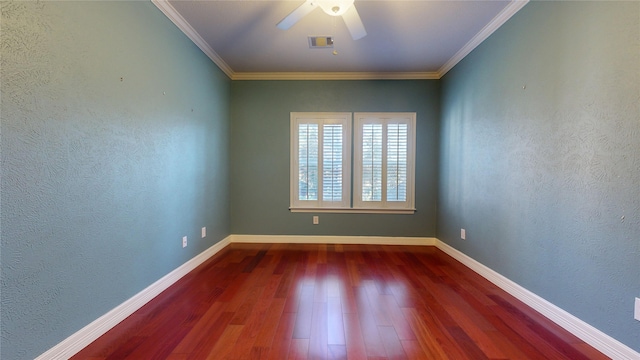 empty room with dark hardwood / wood-style floors, ceiling fan, and crown molding