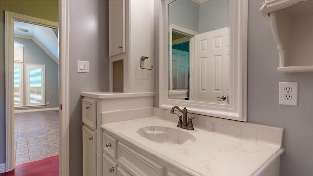 bathroom with vanity and vaulted ceiling