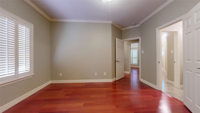 unfurnished room with dark wood-type flooring and ornamental molding