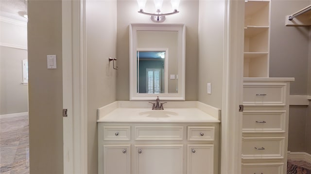 bathroom featuring vanity and ornamental molding