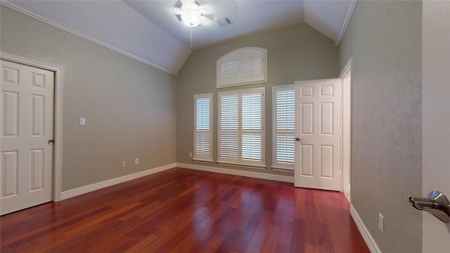 spare room featuring dark hardwood / wood-style floors, ceiling fan, lofted ceiling, and crown molding