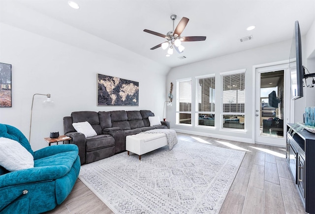 living room with ceiling fan and vaulted ceiling