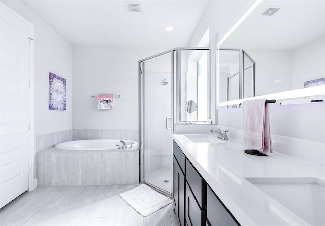 bathroom with vanity, tile patterned floors, and independent shower and bath