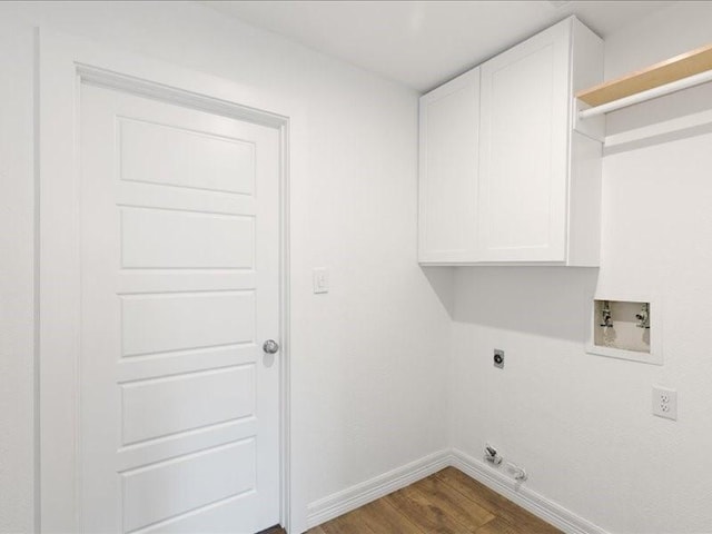 laundry area with electric dryer hookup, washer hookup, dark wood finished floors, cabinet space, and baseboards