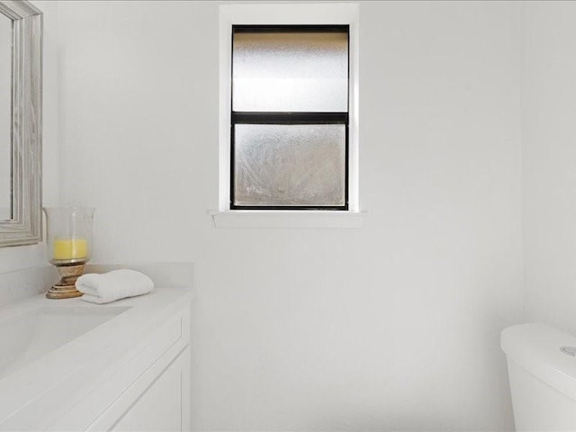 bathroom with toilet and vanity