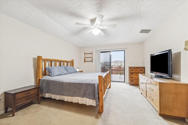 carpeted bedroom featuring access to outside, ceiling fan, and a textured ceiling