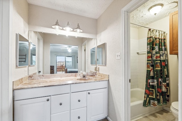 full bathroom featuring vanity, ceiling fan, toilet, a textured ceiling, and shower / tub combo