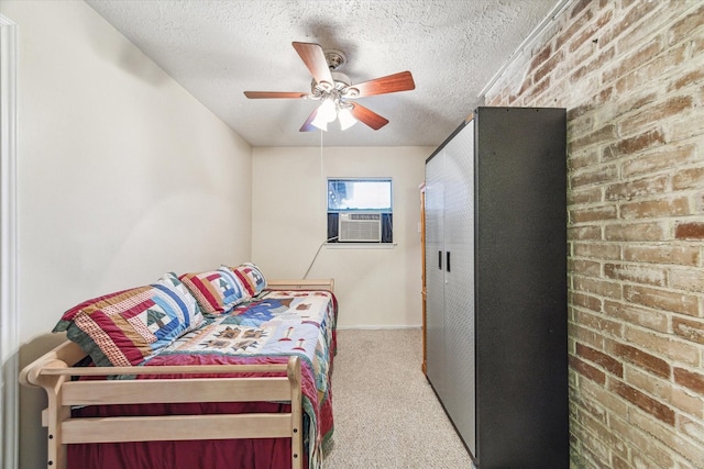 bedroom with light carpet, cooling unit, ceiling fan, a textured ceiling, and brick wall