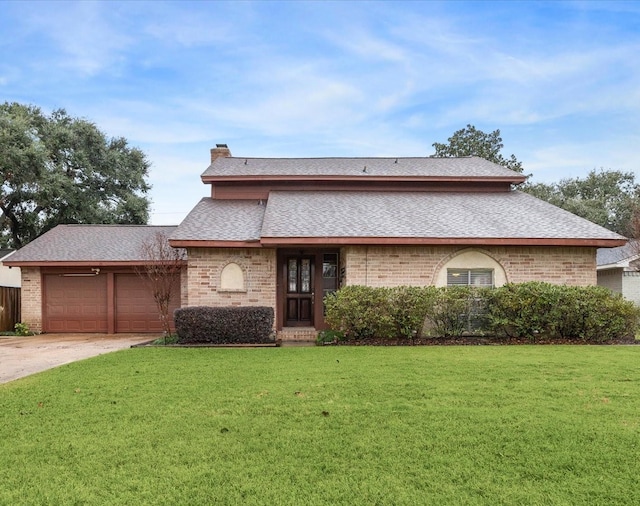 view of front of home with a front yard and a garage