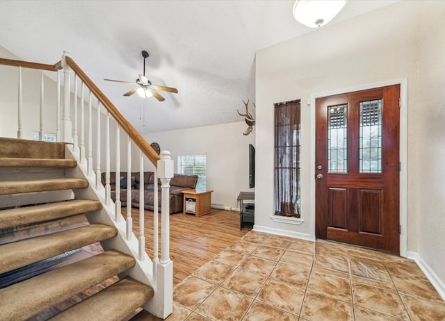 foyer entrance with light tile patterned floors and ceiling fan