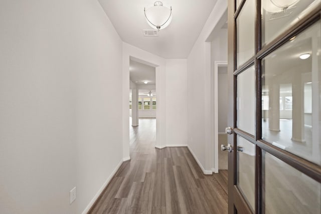 hallway with dark hardwood / wood-style flooring