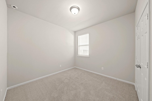 unfurnished bedroom featuring light carpet