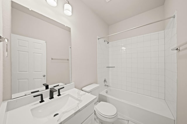 full bathroom with vanity, tiled shower / bath combo, and toilet