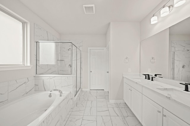 bathroom featuring plenty of natural light, vanity, and independent shower and bath