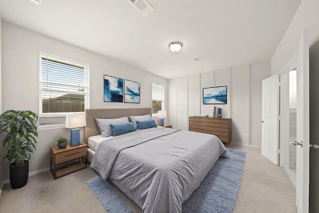 carpeted bedroom with multiple windows