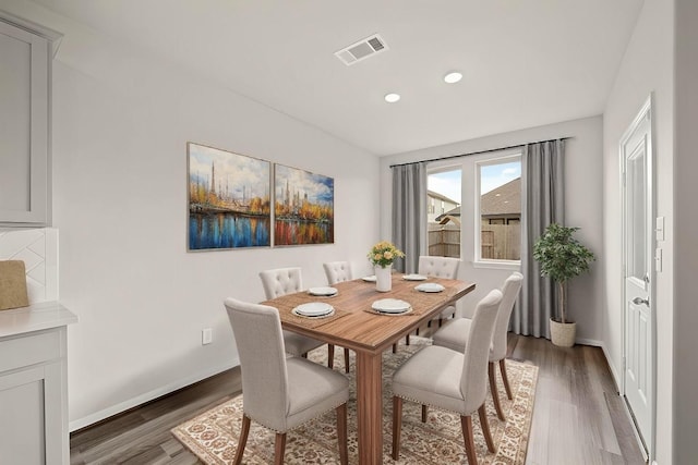 dining area with dark hardwood / wood-style flooring