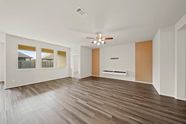 unfurnished living room featuring hardwood / wood-style floors and ceiling fan