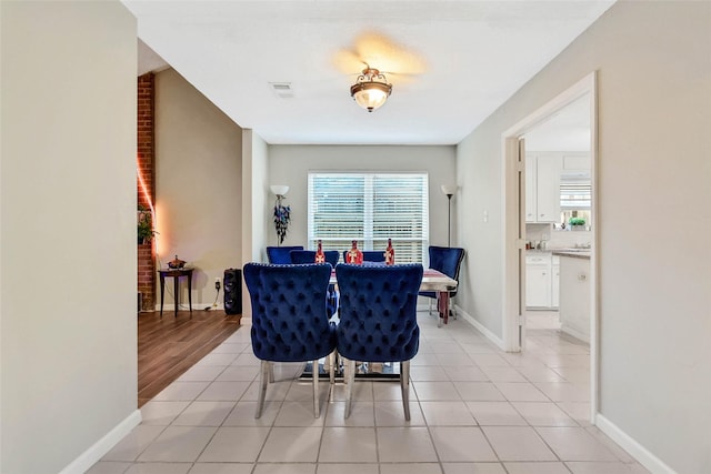 dining area with light tile patterned floors