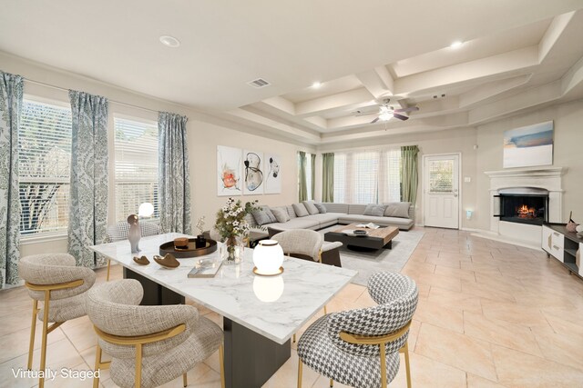 dining room with a tray ceiling, ceiling fan, and coffered ceiling