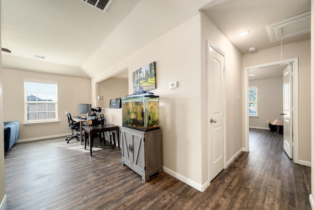 home office with dark hardwood / wood-style flooring and lofted ceiling