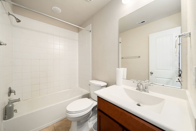 full bathroom with tile patterned flooring, vanity, tiled shower / bath combo, and toilet