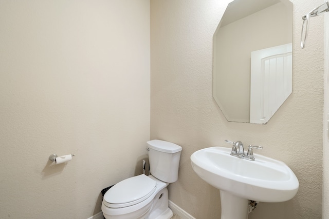 bathroom with toilet and sink