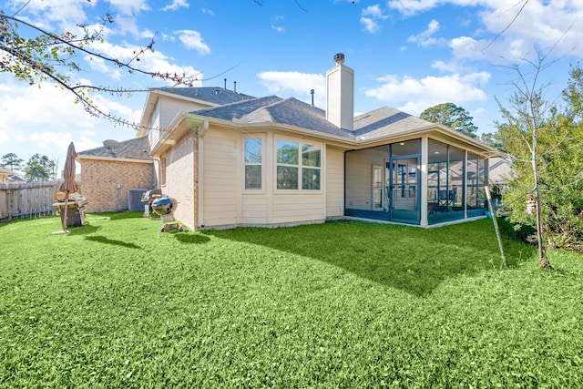 back of house featuring a lawn, a sunroom, and cooling unit