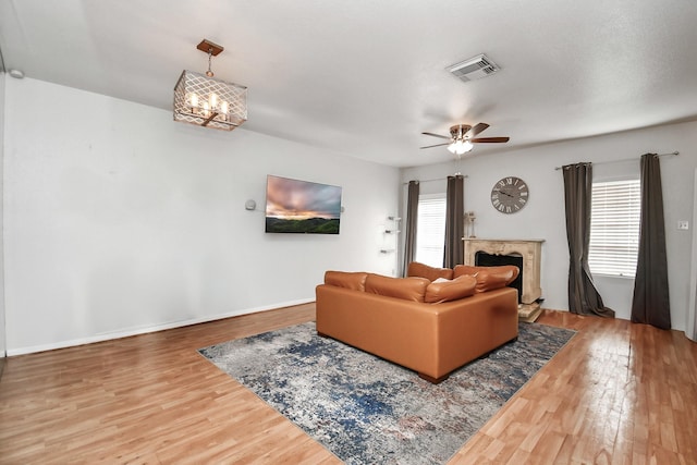 living room featuring a wealth of natural light, a fireplace, and hardwood / wood-style floors