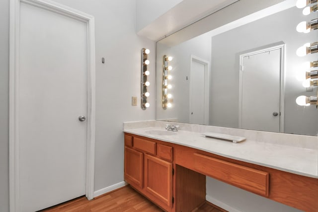 bathroom featuring hardwood / wood-style flooring and vanity