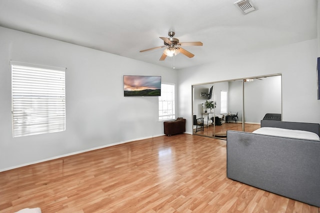 living room featuring hardwood / wood-style floors and ceiling fan