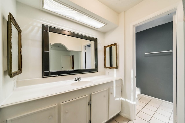 bathroom with tile patterned floors, vanity, and toilet