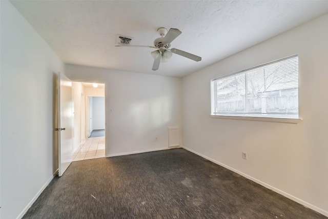 unfurnished room with ceiling fan