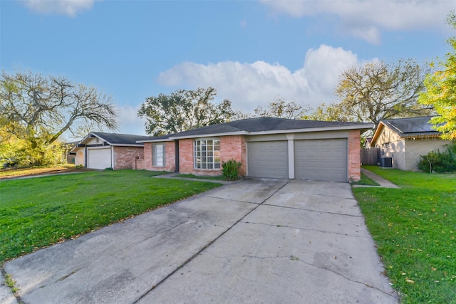 ranch-style house with a garage, central air condition unit, and a front lawn