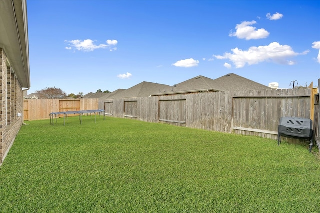 view of yard with a trampoline