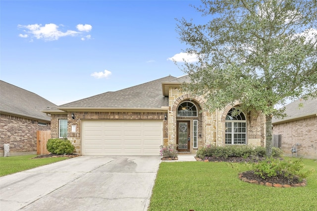 view of front of house featuring a front yard and a garage