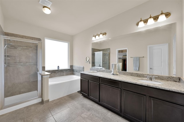 bathroom with tile patterned flooring, vanity, and independent shower and bath