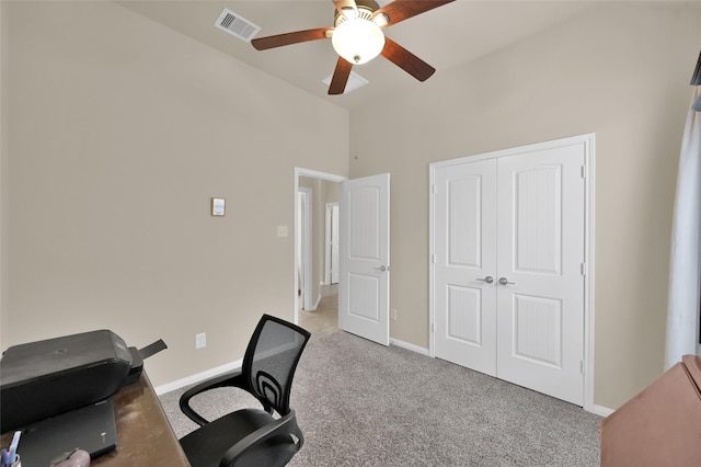 home office with ceiling fan and light carpet