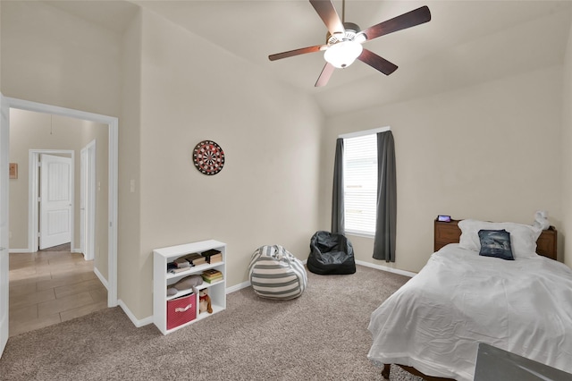 carpeted bedroom with vaulted ceiling and ceiling fan