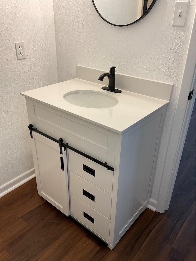 bathroom with vanity and hardwood / wood-style floors