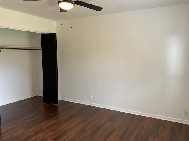 unfurnished bedroom featuring a closet, dark hardwood / wood-style floors, and ceiling fan