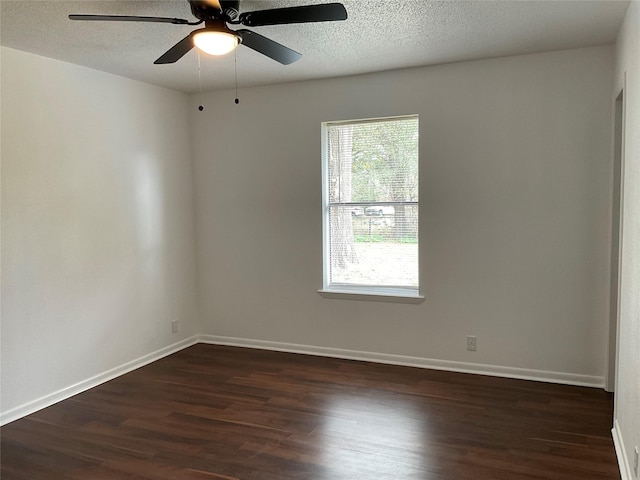 empty room with dark hardwood / wood-style flooring, ceiling fan, and a textured ceiling