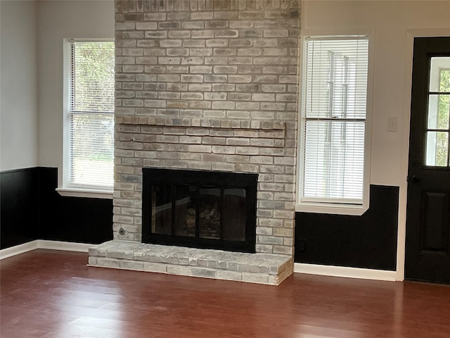 interior details featuring hardwood / wood-style flooring and a fireplace