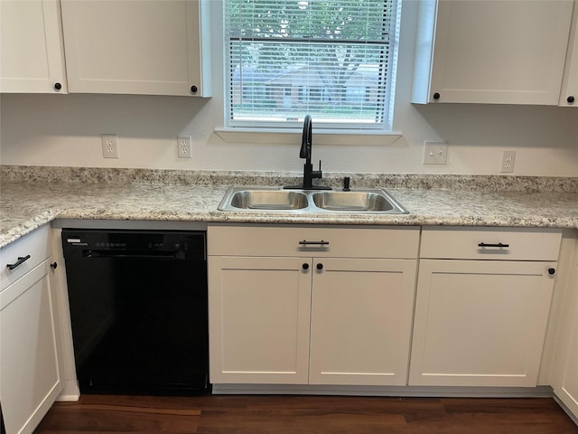 kitchen featuring white cabinetry, black dishwasher, and sink