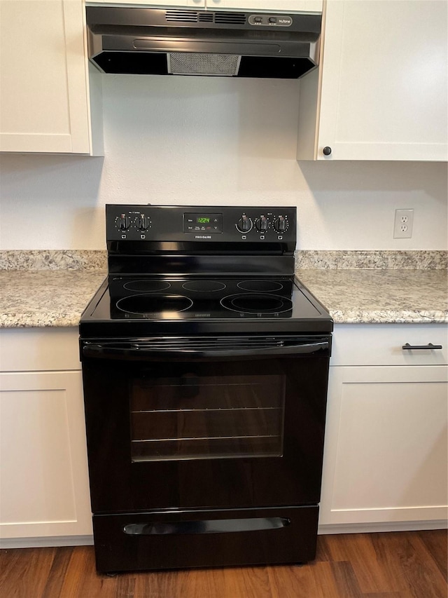 kitchen featuring white cabinetry, black range with electric stovetop, and light stone countertops