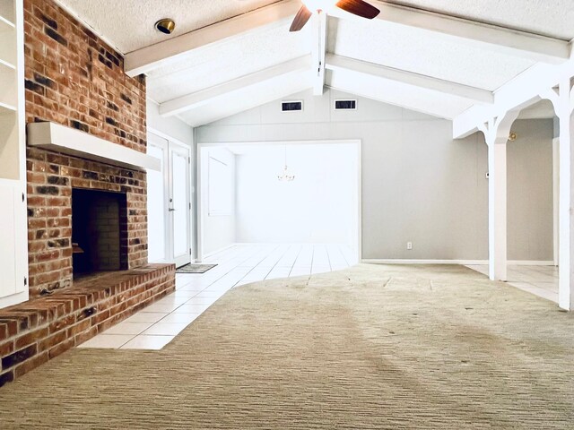 unfurnished living room with ceiling fan, lofted ceiling with beams, a textured ceiling, light carpet, and a fireplace