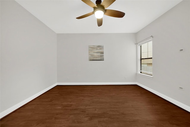 spare room with dark hardwood / wood-style flooring and ceiling fan