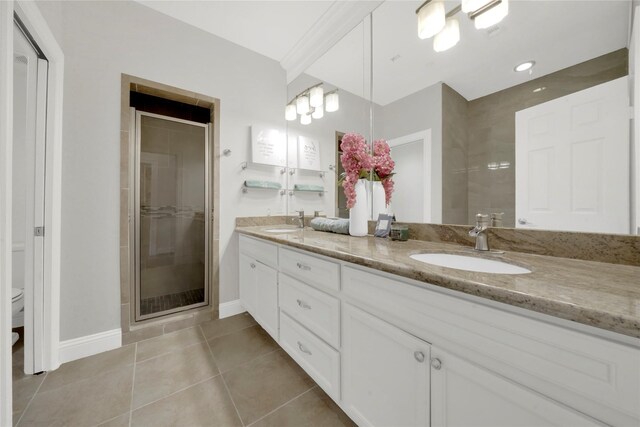 bathroom with tile patterned flooring, vanity, an enclosed shower, and toilet