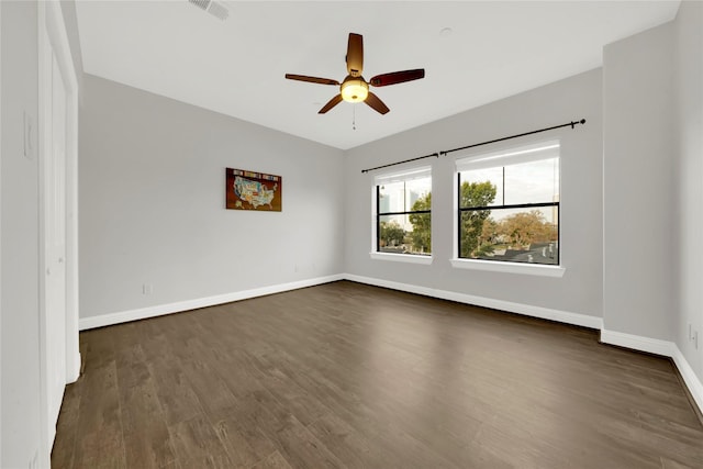 unfurnished room with dark hardwood / wood-style flooring and ceiling fan