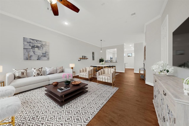 living room with dark hardwood / wood-style floors, ceiling fan, and crown molding